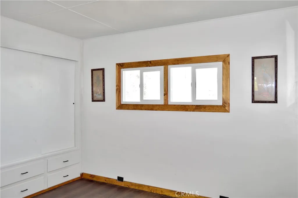 The Main Bedroom Next Door has a Barn Door Entry, Modern Lighting, Dual Closets with Drawers Below, and More Storage Hidden Behind the Barn Door The Main Bedroom Next Door has a Barn Door Entry, Modern Lighting, Dual Closets with Drawers Below, and More Storage Hidden Behind the Barn Door