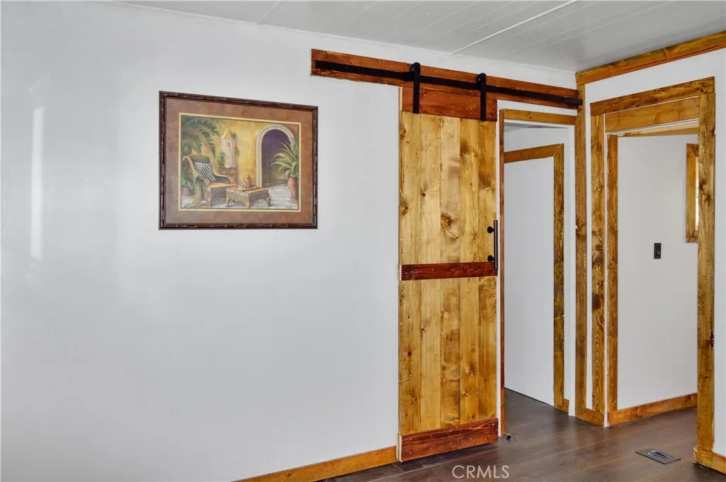The Main Bedroom Next Door has a Barn Door Entry, Modern Lighting, Dual Closets with Drawers Below, and More Storage Hidden Behind the Barn Door The Main Bedroom Next Door has a Barn Door Entry, Modern Lighting, Dual Closets with Drawers Below, and More Storage Hidden Behind the Barn Door