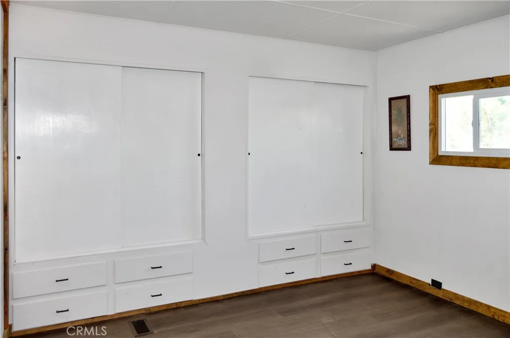 The Main Bedroom Next Door has a Barn Door Entry, Modern Lighting, Dual Closets with Drawers Below, and More Storage Hidden Behind the Barn Door The Main Bedroom Next Door has a Barn Door Entry, Modern Lighting, Dual Closets with Drawers Below, and More Storage Hidden Behind the Barn Door