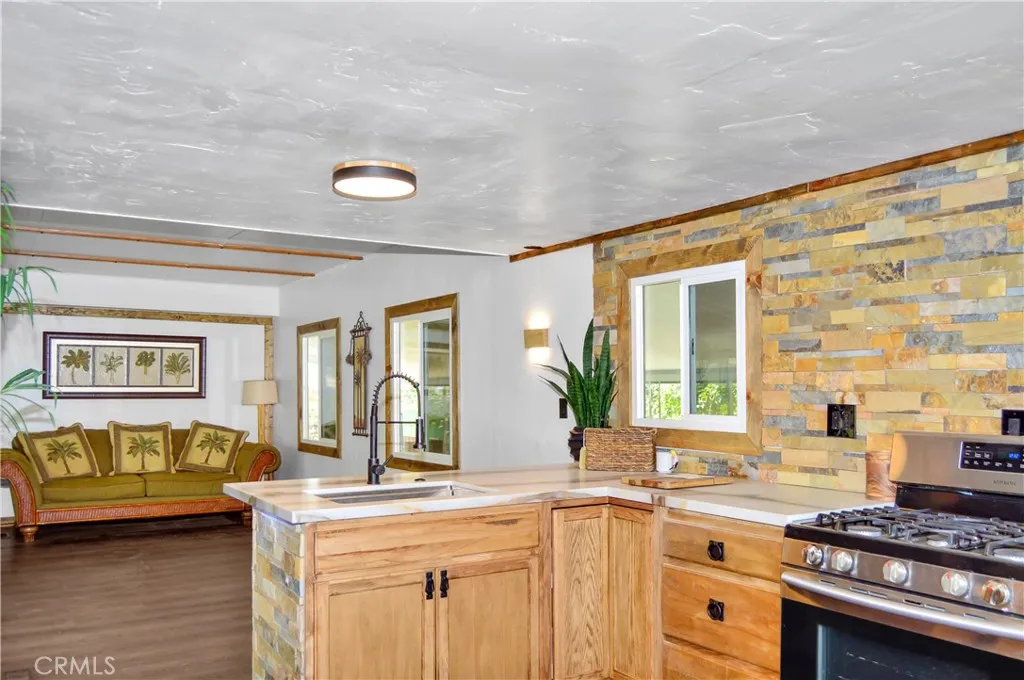 Welcome Home to Space 16 in Yucaipa Village - a 55+ Community! Here's a Sneak Peek at the Big, Beautiful Kitchen with New Cabinetry, Quartz Countertops, Stainless Steel Sink with Sprayer, Stainless Steel and Black Range, Wood and Stone Accents, Custom Lighting, Black Hardware, and More! Check out the photos and virtual tours! Welcome Home to Space 16 in Yucaipa Village - a 55+ Community! Here's a Sneak Peek at the Big, Beautiful Kitchen with New Cabinetry, Quartz Countertops, Stainless Steel Sink with Sprayer, Stainless Steel and Black Range, Wood and Stone Accents, Custom Lighting, Black Hardware, and More! Check out the photos and virtual tours!