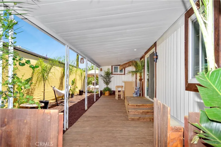 New Front Gate Leads to the New Wood Deck under the Covered Patio with Tropical Plants, a Tiki Bar, a Hammock, and a Fire Pit to Truly Enjoy Your Tropical Oasis! Yes, Everything is Included!