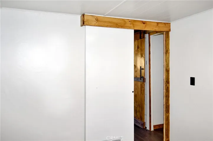 The 2nd Bedroom is Accessed via the Main Bedroom and Offers More Closet Space with Drawers Below, Hook-ups for a Stackable Washer/Dryer, and Another Sliding Entry Door