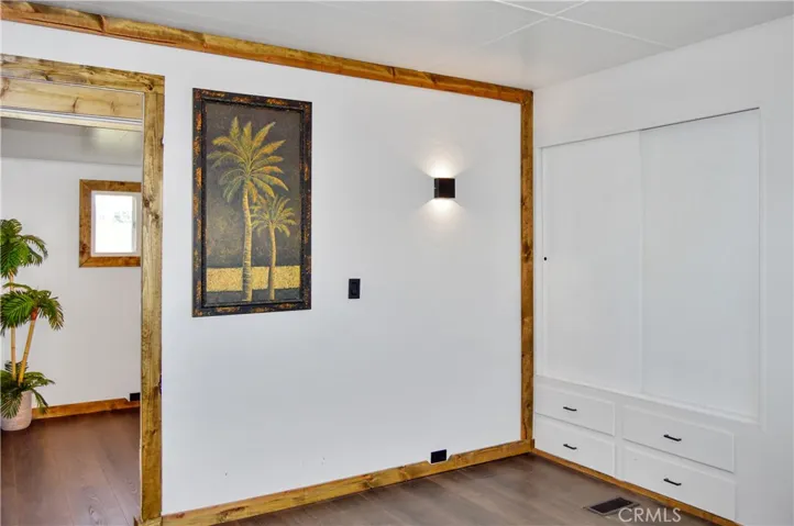 The Main Bedroom Next Door has a Barn Door Entry, Modern Lighting, Dual Closets with Drawers Below, and More Storage Hidden Behind the Barn Door