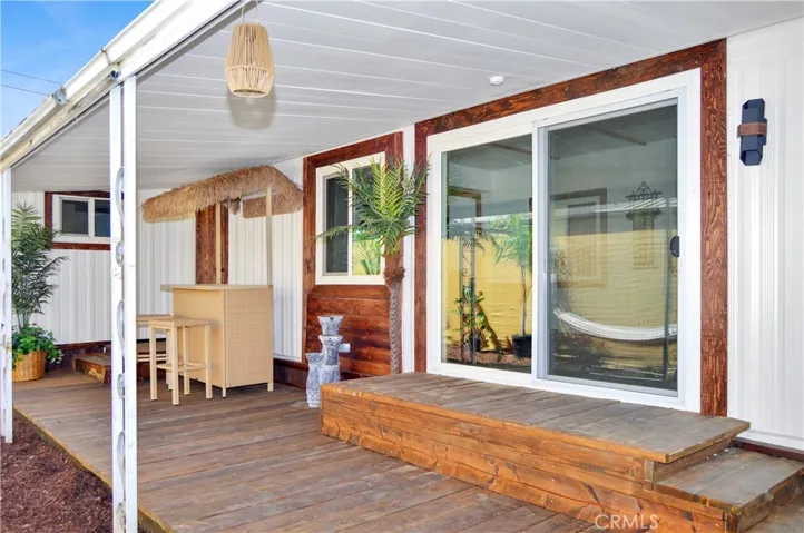 New Front Gate Leads to the New Wood Deck under the Covered Patio with Tropical Plants, a Tiki Bar, a Hammock, and a Fire Pit to Truly Enjoy Your Tropical Oasis! Yes, Everything is Included!