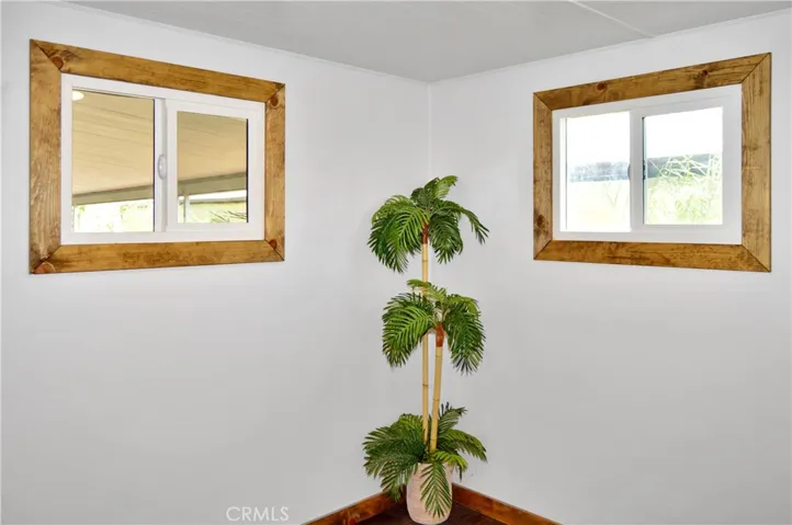The 2nd Bedroom is Accessed via the Main Bedroom and Offers More Closet Space with Drawers Below, Hook-ups for a Stackable Washer/Dryer, and Another Sliding Entry Door