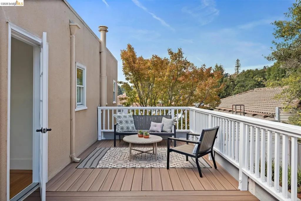 Deck with wood-finish flooring and white railings, featuring direct access via a white door Deck with wood-finish flooring and white railings, featuring direct access via a white door