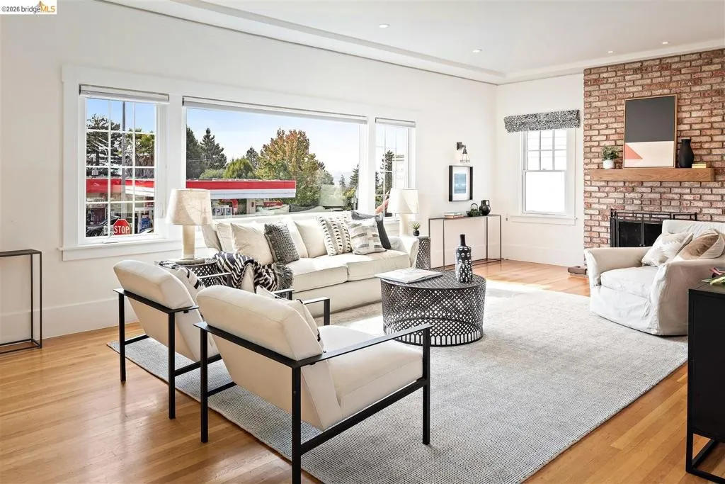 Exposed brick fireplace with a wood mantel Exposed brick fireplace with a wood mantel
