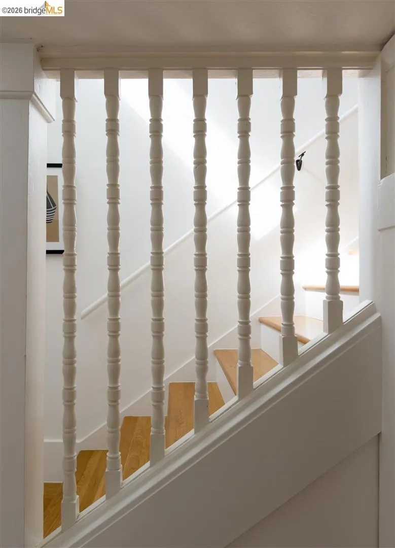 Wood-finish treads with painted balusters and a painted handrail Wood-finish treads with painted balusters and a painted handrail