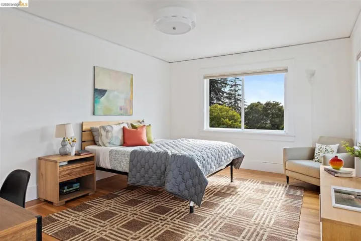 Hardwood flooring, crisp white walls, single window, recessed lighting, and a light-colored ceiling