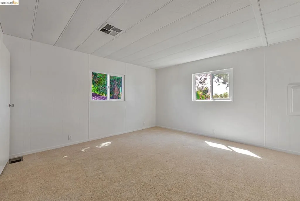 Carpeted empty room with plenty of natural light