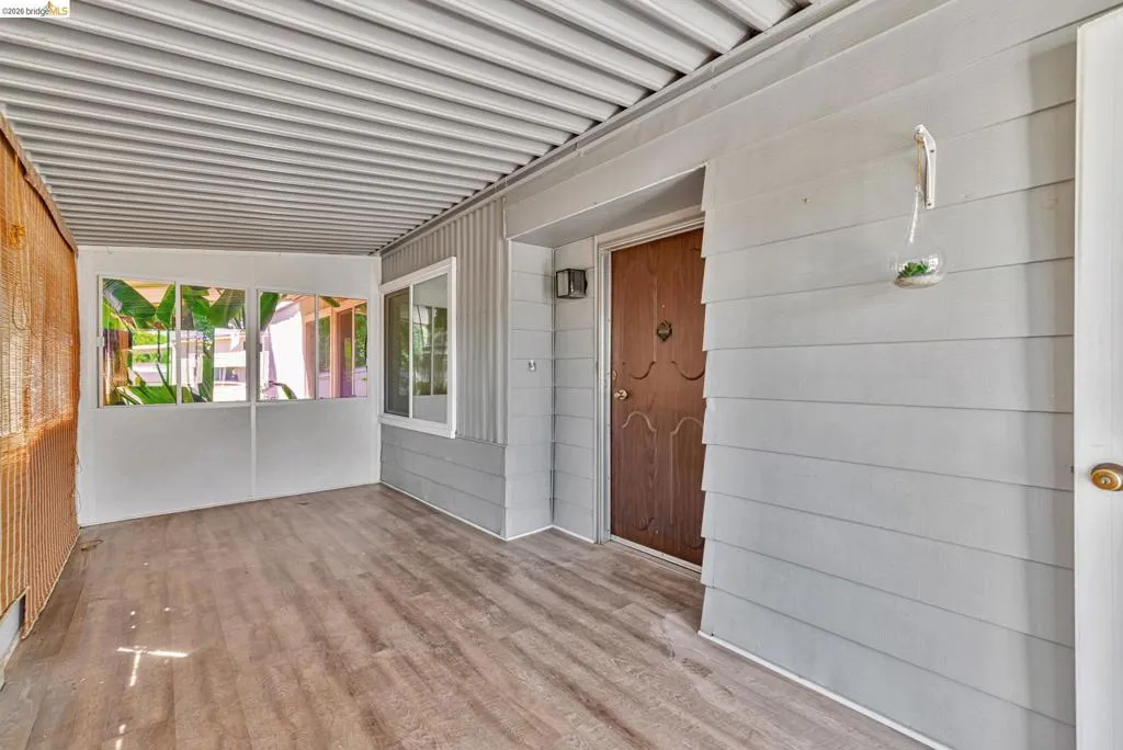 Property entrance featuring a sunroom