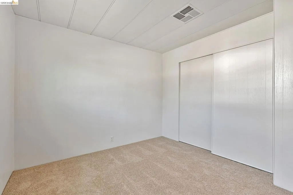 Unfurnished bedroom with carpet floors and a closet