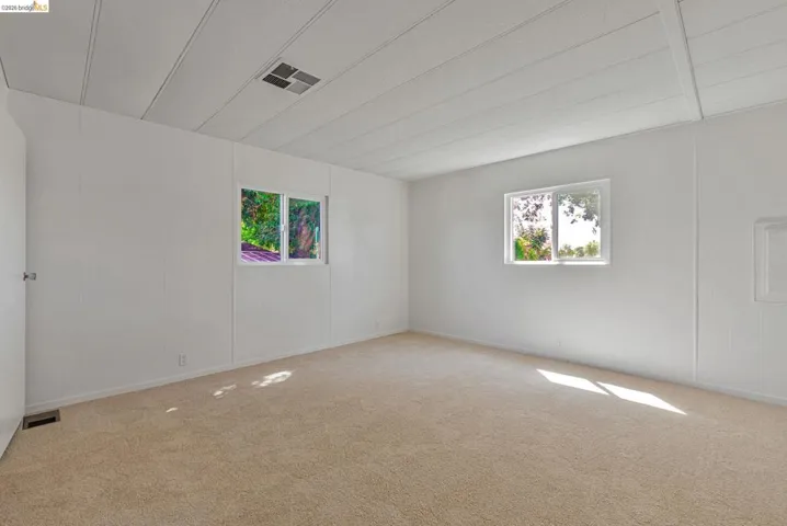 Carpeted empty room with plenty of natural light