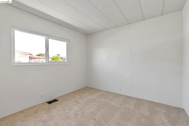 Unfurnished room with carpet flooring