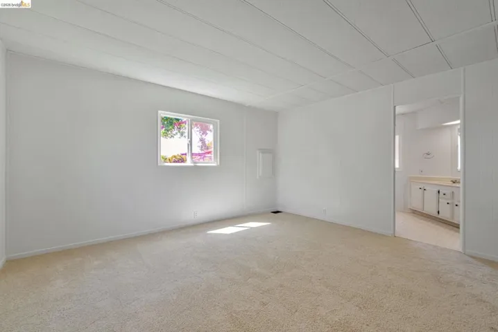 Spare room featuring light colored carpet