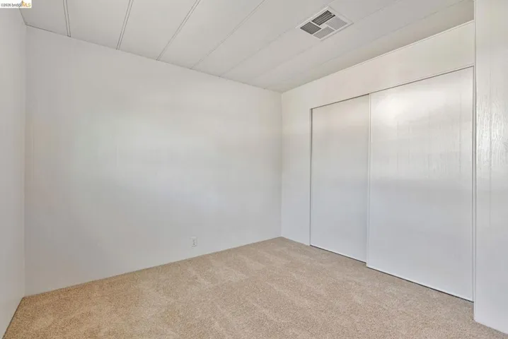 Unfurnished bedroom with carpet floors and a closet