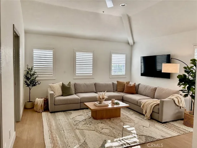 AI Staged as Family room. The door on the left side is a BR