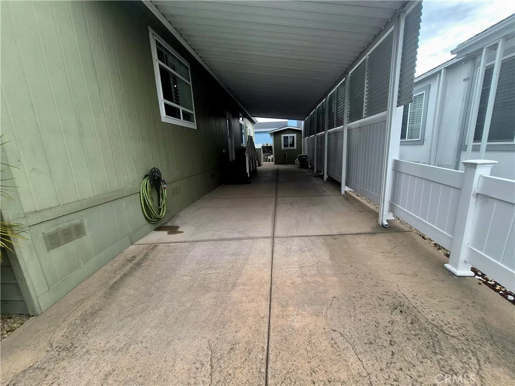 There's room for at least 2 cars in this covered carport. There's room for at least 2 cars in this covered carport.