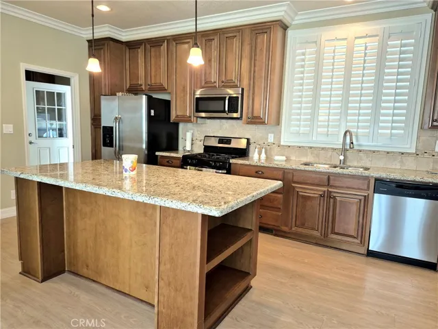 Dine at the generous kitchen island with shelves at both ends.