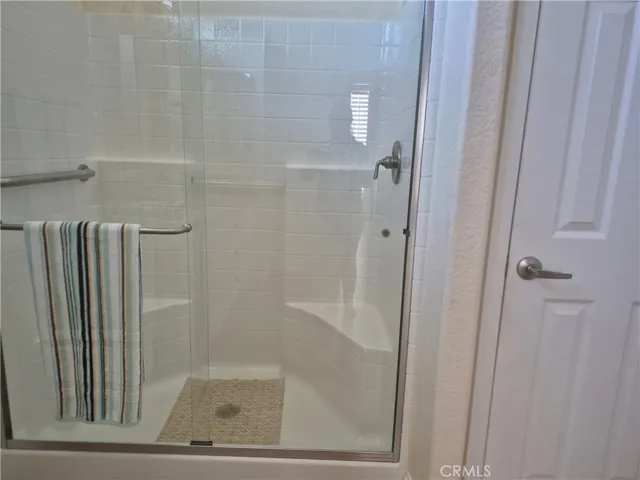 Large walk-in shower with seating.