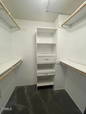Primary bedroom walk in closet