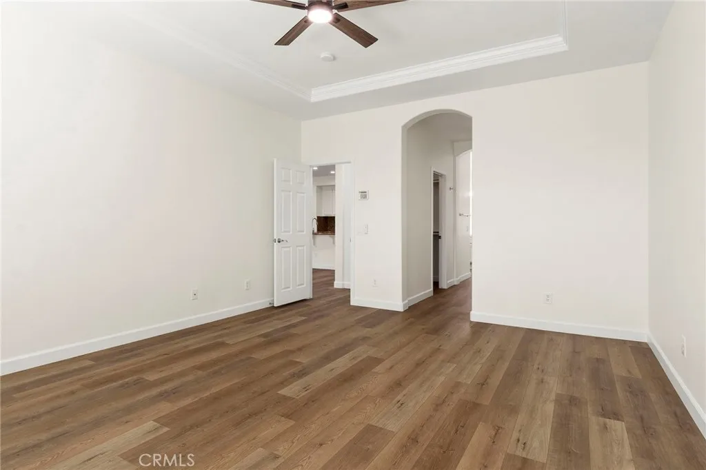 Primary bedroom archway leads to TWO walk in closets and luxurious primary bath Primary bedroom archway leads to TWO walk in closets and luxurious primary bath