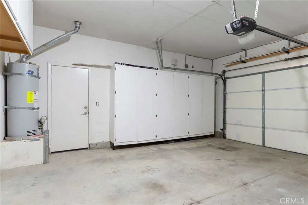 Direct access garage has storage cabinets and roll up door Direct access garage has storage cabinets and roll up door