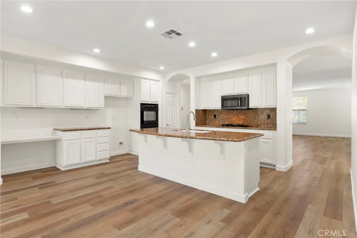 Kitchen is nicely framed by stunning dual archways.