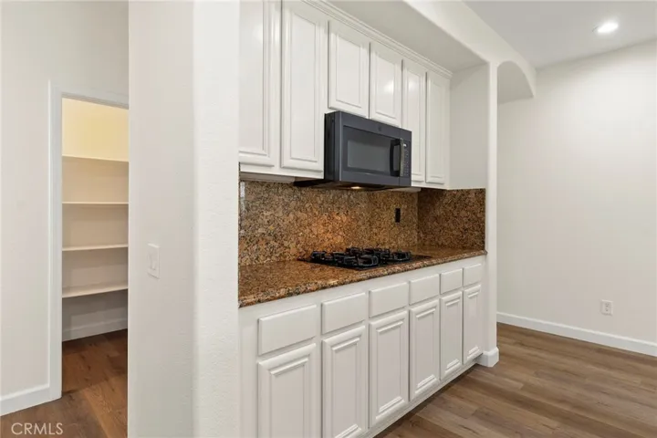 Tons of cupboards in kitchen PLUS a walk in pantry in the hallway behind