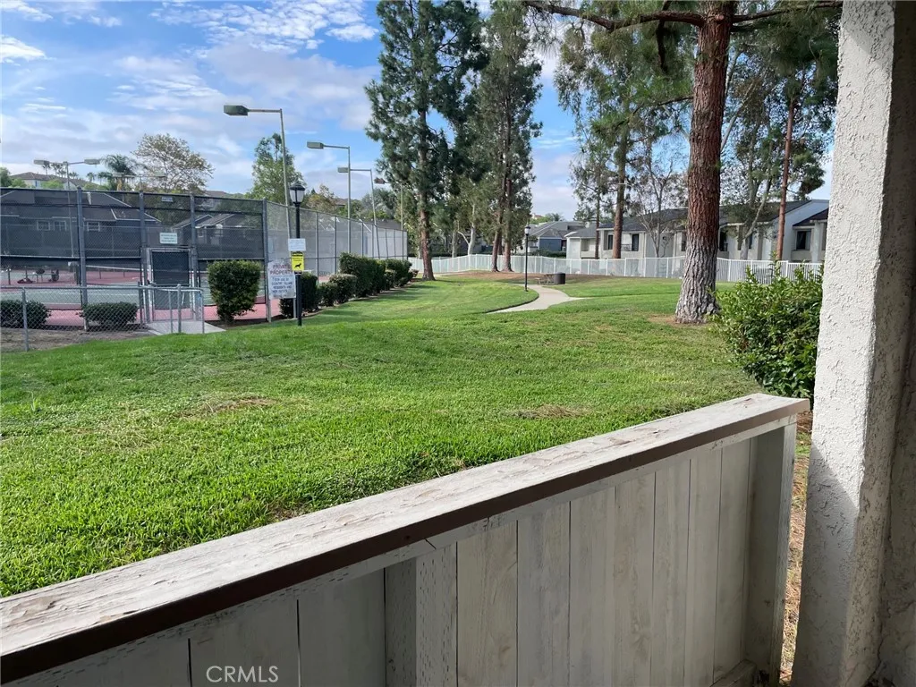 Patio with view of green belt and tennis courts Patio with view of green belt and tennis courts
