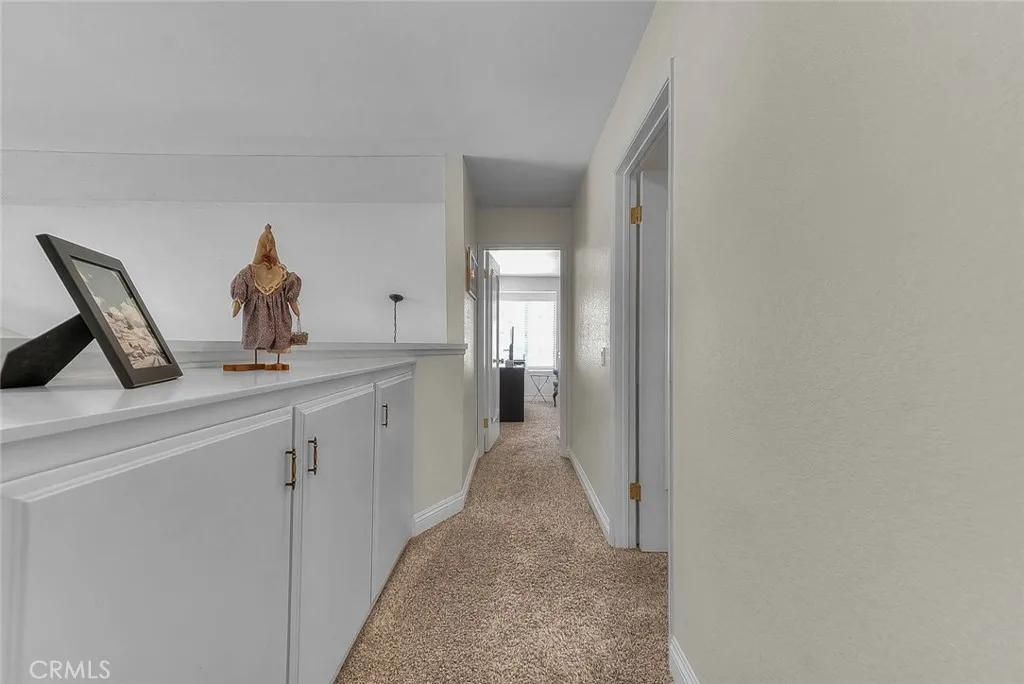 Hallway separates secondary bedrooms from primary suite Hallway separates secondary bedrooms from primary suite