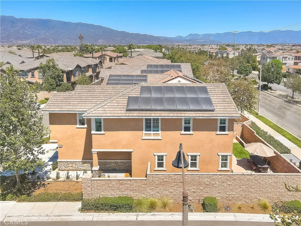 Elevated view showcasing the home’s side profile and corner-lot location.
