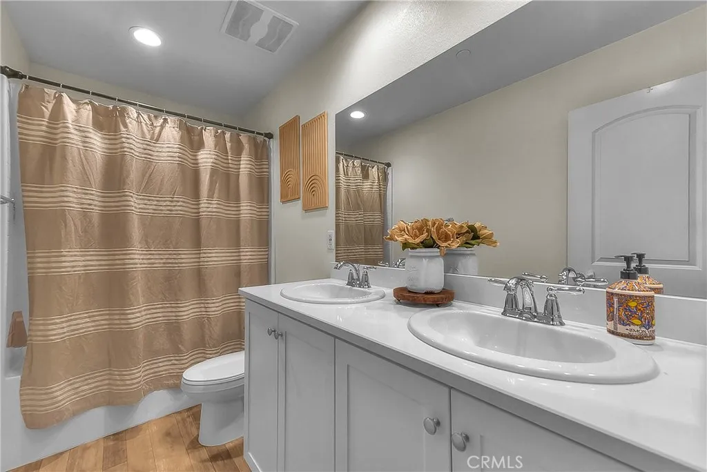 Convenient hall bathroom with dual sink serving the secondary bedrooms and living areas.