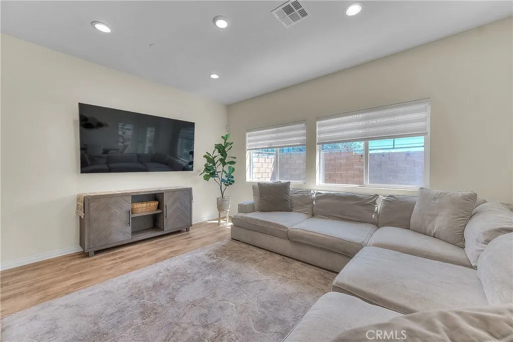 Spacious living area featuring a clean, modern feel and plenty of natural light.