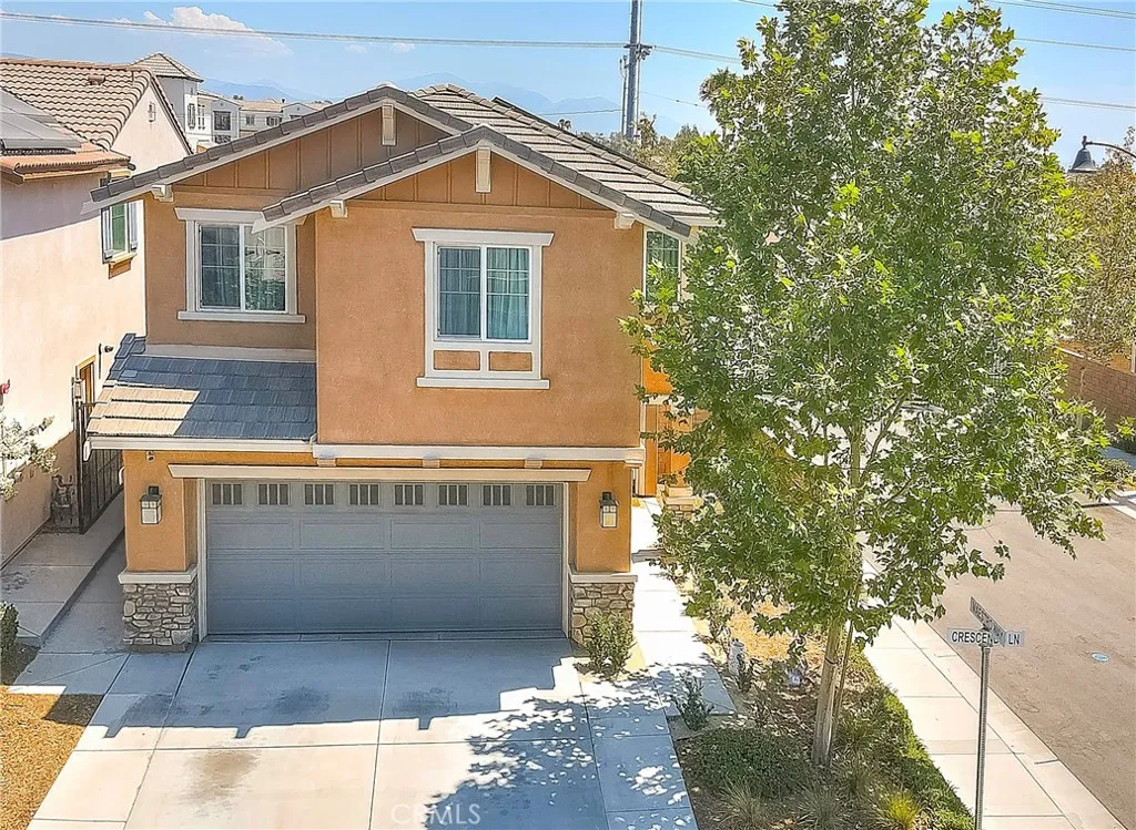 Beautifully landscaped corner-lot home with an inviting entrance and charming curb appeal.