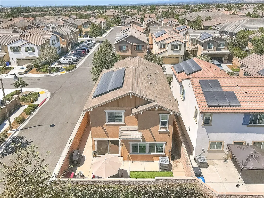 Elevated view showcasing the home’s backyard profile and corner-lot location.