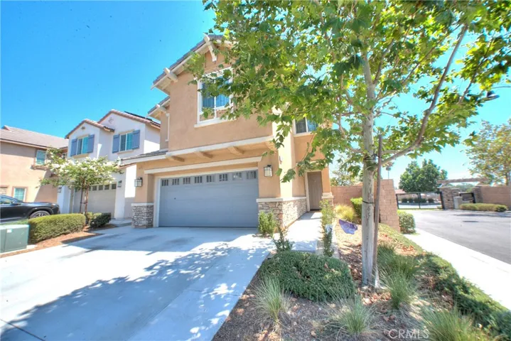 Charming exterior showcasing the home’s attractive curb appeal, corner-lot setting, and well-maintained landscaping.