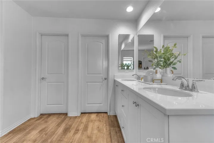 Well-appointed primary bathroom with a generous walk-in closet for added storage and convenience.
