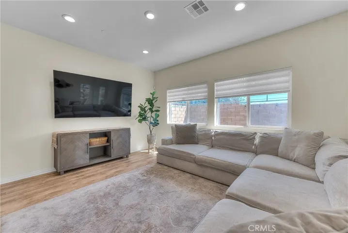 Spacious living area featuring a clean, modern feel and plenty of natural light.