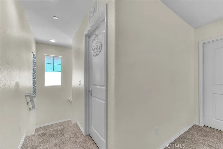 Second-level hallway with convenient access to the indoor laundry room.