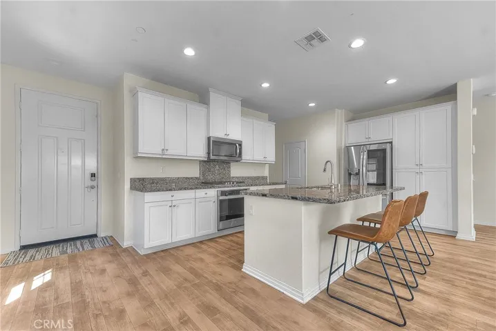 The kitchen’s open layout provides an inviting gathering space for cooking and entertaining.