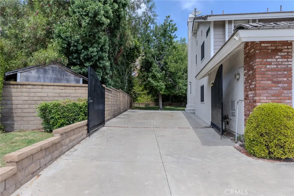 Huge gated RV parking on left side of the house.