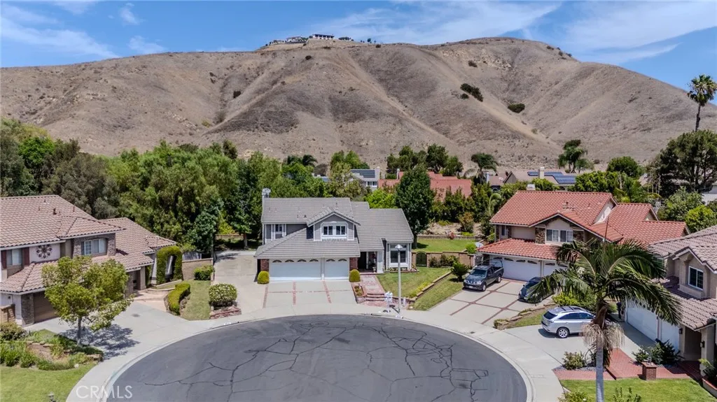 Aerial view of the culdesac location with massive gated RV parking to the left and enormous right side yard with abundant space for a pool area.