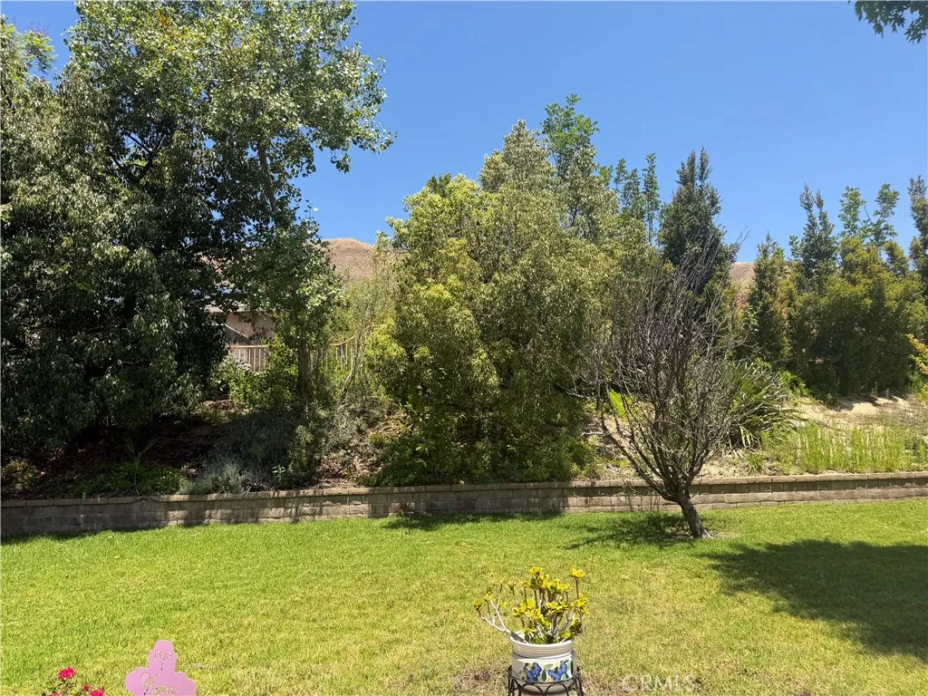 From the back side of the patio looking at the gently sloping raised planter at the rear of the lot and the surrounding hills.