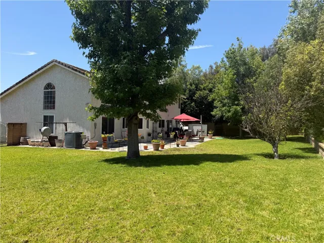 A view from the far corner and the wide open space on the right side of the home. Definitely plenty of room for a fabulous pool area!