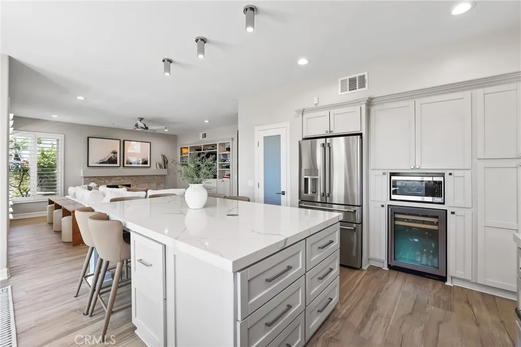 Tastefully updated kitchen with a breakfast bar, wine frig, and seamlessly flows into a spacious great room Tastefully updated kitchen with a breakfast bar, wine frig, and seamlessly flows into a spacious great room