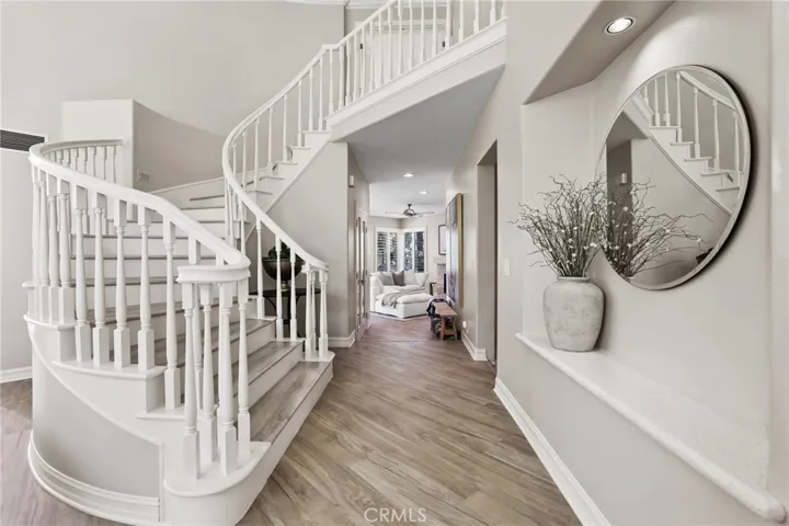 Stunning wide plank floors throughout~sweeping staircase leads to 4 upstairs bedrooms