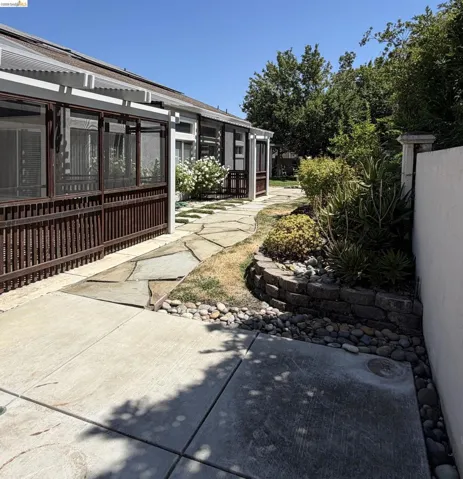 Screened patio enclosure with a slatted privacy wall