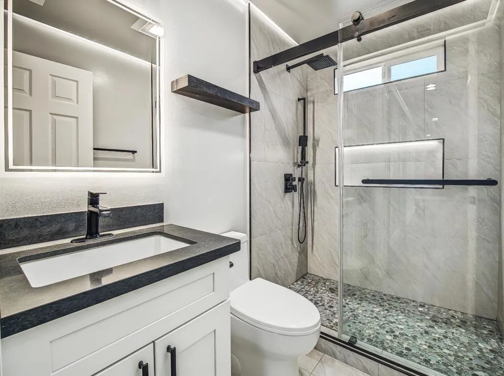 Custom Bright hallway bath with recess lighting. Modern mirror w/lites & defogger. Custom Bright hallway bath with recess lighting. Modern mirror w/lites & defogger.
