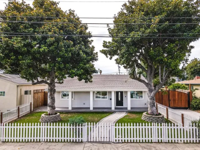 Cute and cozy home with white picket fence.